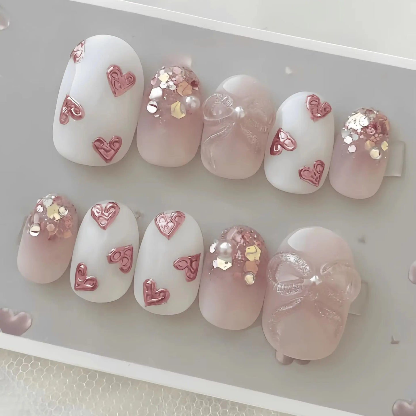 10 Pieces of Handmade Almond-Shaped Full-Cover Nail Tips, Medium Length, with Nude Pink Gradient and Translucent Base, Featuring Embossed Pink Hearts, Glitter Sequins, and Fine Glitter Bow Pearl Decorations, in a Gentle and S